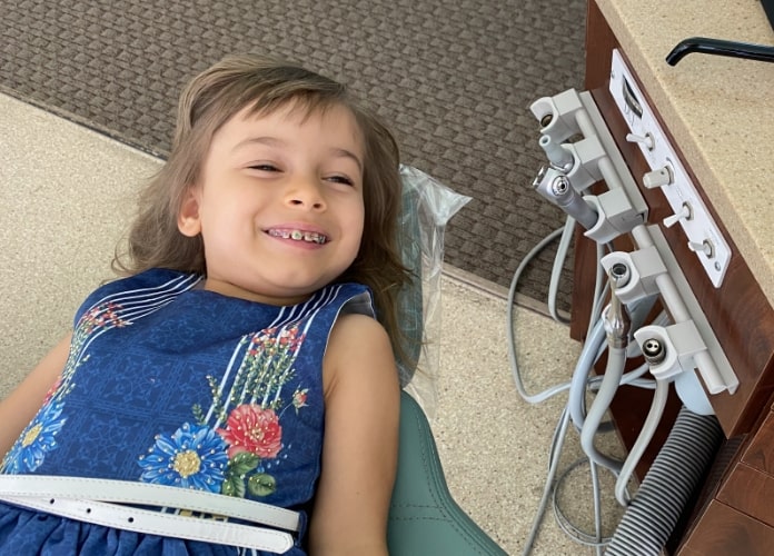 a young pediatric airway patient of Dr. Kevin Adair shows off her amazing smile