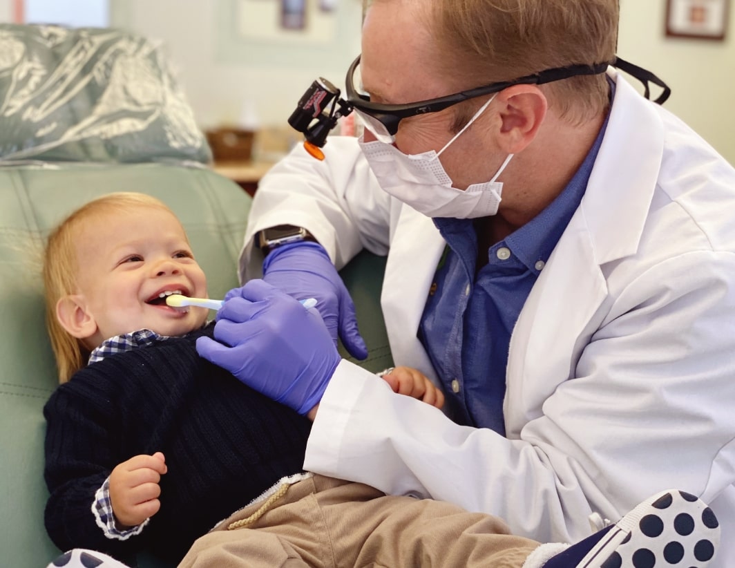Dr. Kevin Adair, Sacramento Airway Orthodontist looks at a young patients mouth
